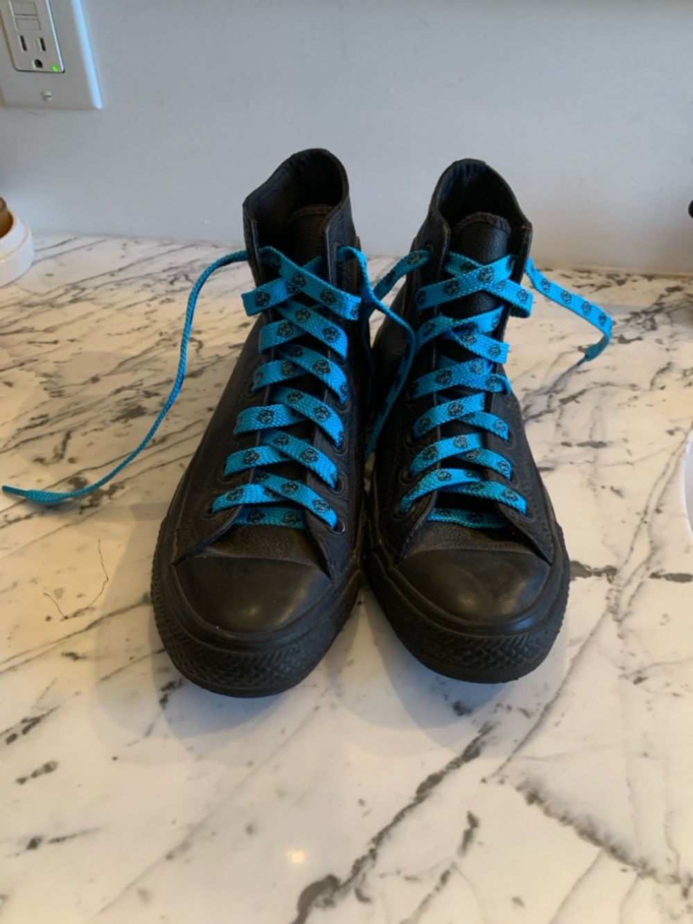 Woman’s Converse Black High-Top Sneakers with Blue Laces